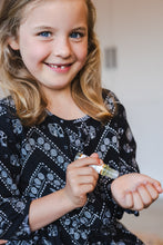 Load image into Gallery viewer, Girl using lavender roller to calm down