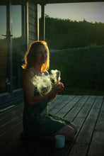 Load image into Gallery viewer, woman using a smoke wand to clear energy